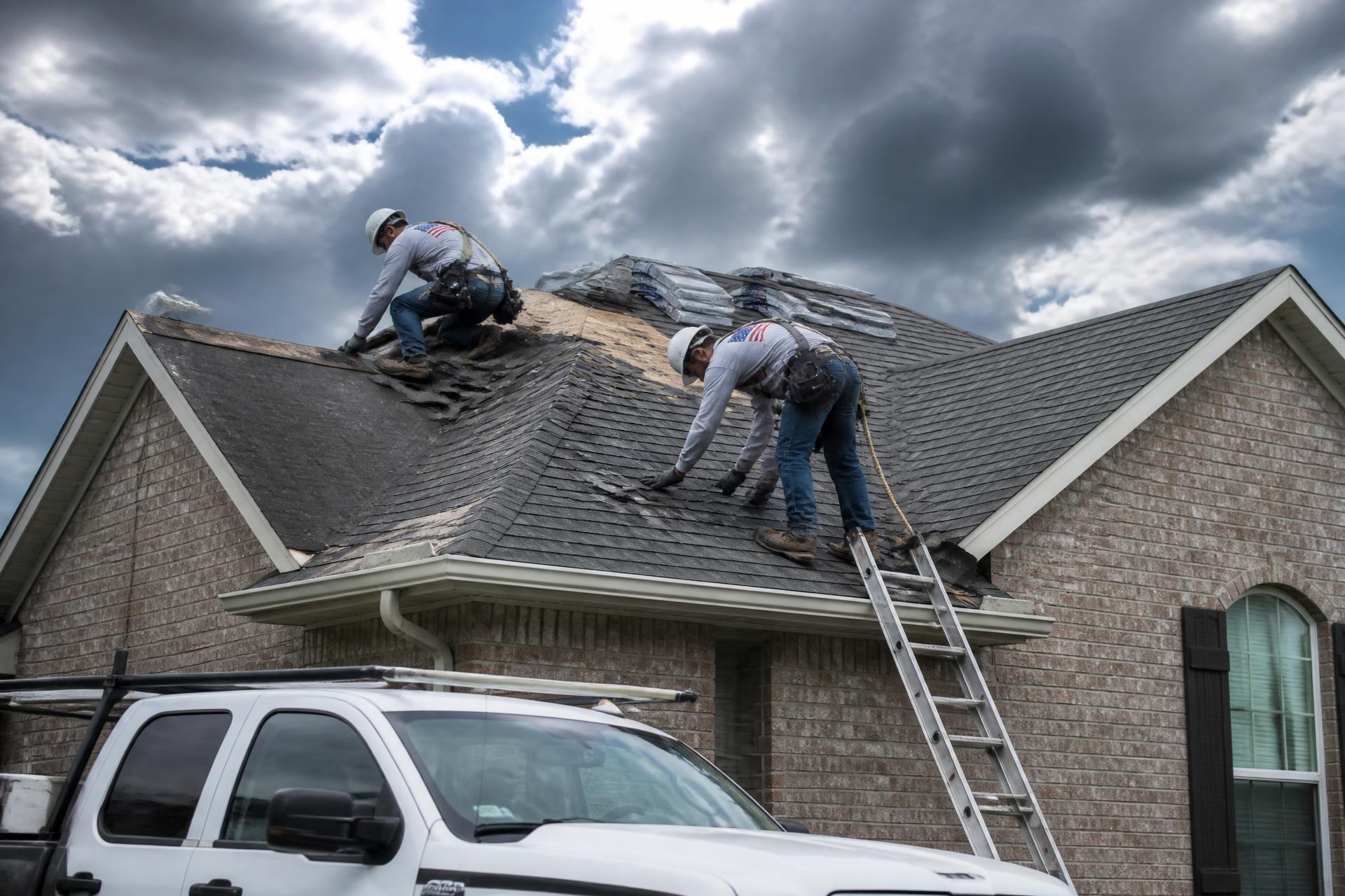 Roofing crew replacing shingles on a San Antonio home under a dramatic Texas sky